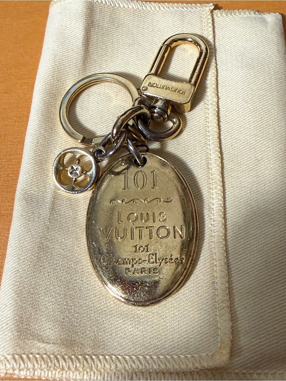 Louis Vuitton Gold-Tone Oval 101 Key Charm with Fleur Motif with dust bag & box